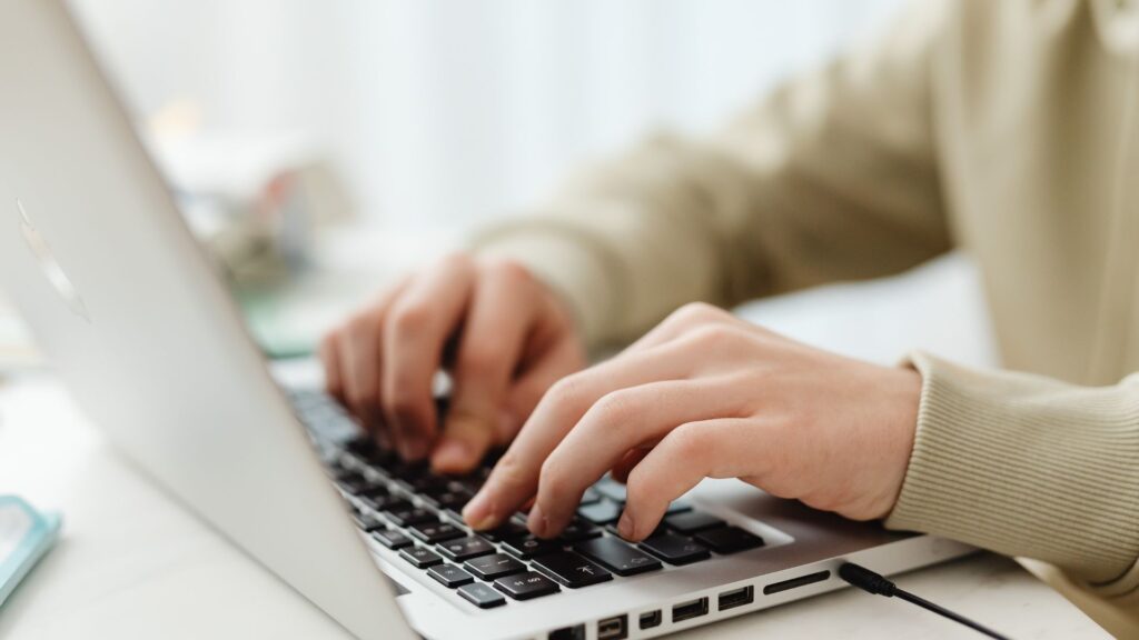 Person typing on laptop